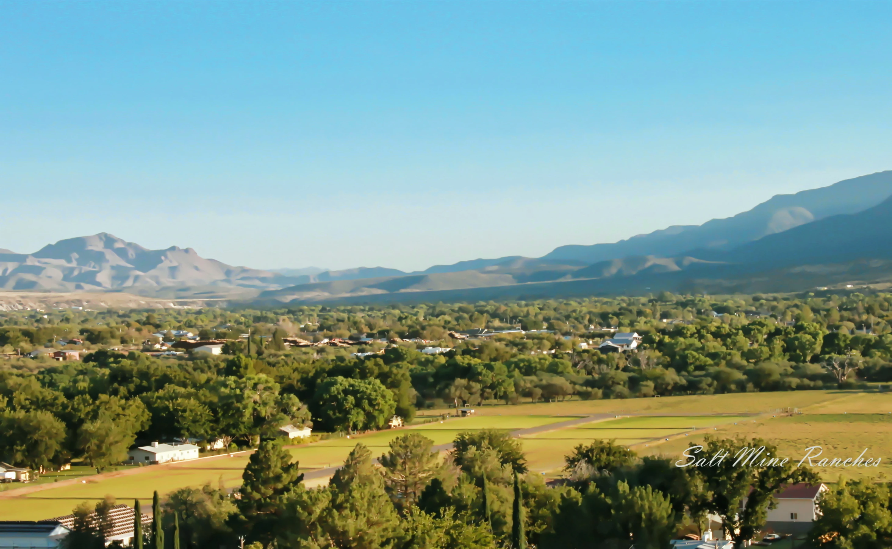 Aerial view of saltmine ranches showing mountains in background